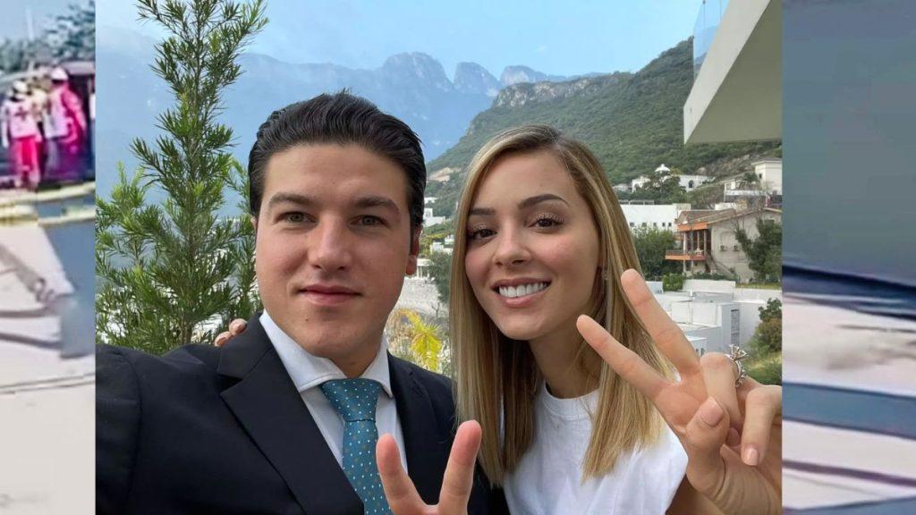 Couple Taking a Selfie Outdoors with Mountains in the Background; Man in a Suit and Teal Tie, Woman in a White Shirt, Both Smiling and Showing Peace Signs - La Razón Nl