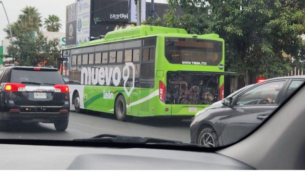 Green City Bus with Its Rear Maintenance Compartment Open, Driving in Traffic Seen from Inside a Car Window - La Razón Nl