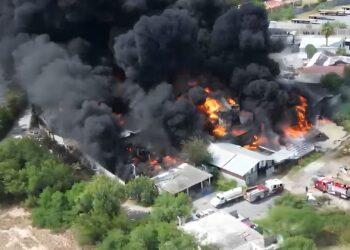 Aerial View of a Large Fire with Thick Black Smoke and Bright Orange Flames Consuming Multiple Buildings in a Residential Area. - La Razón Nl