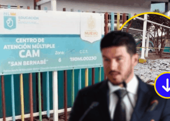 Blurred Man in a Suit Speaking at a Microphone in Front of a Sign for Centro De Atención Múltiple Cam San Bernabé with a Colorful Fence Behind. - La Razón Nl
